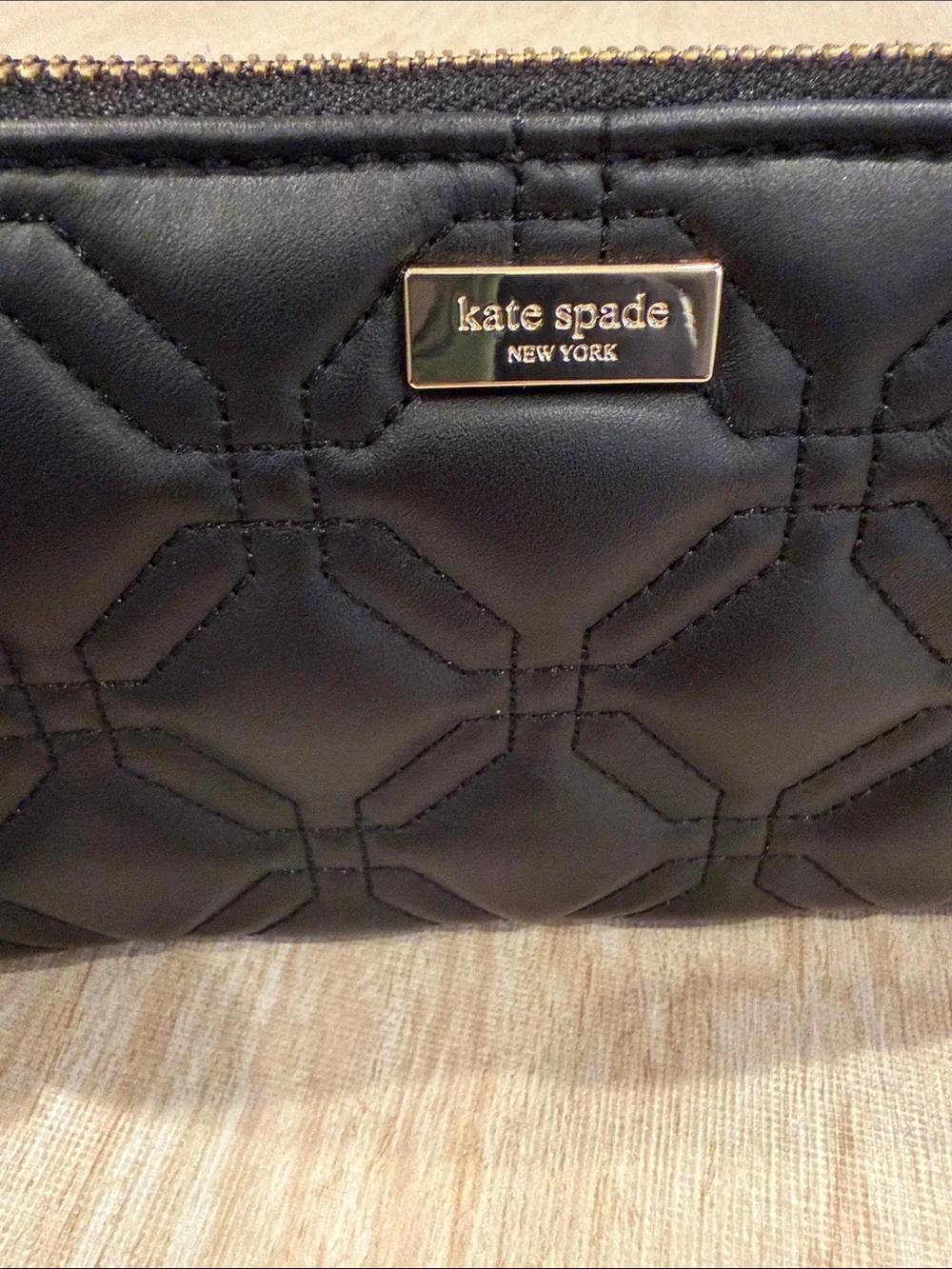 kate spade black quilted zip-around wallet with gold plaque